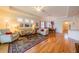 Bright living space features hardwood floors, comfortable seating, and an open floor plan connecting to the dining area at 2313 Nottingham Greens Dr # 2313, Sun City Center, FL 33573