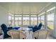 Sunroom with tile flooring, fan, and expansive windows with lake views at 2313 Nottingham Greens Dr # 2313, Sun City Center, FL 33573