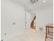 Laundry room with marble floor and view to stairway with patterned stair runner at 26 W Orange St, Tarpon Springs, FL 34689