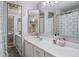 Bathroom featuring a dual-sink vanity, mirrored cabinets, and a patterned shower curtain at 2612 6Th Ct, Palm Harbor, FL 34684