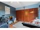 Cozy bedroom featuring ample closet space and a unique touch with a decorative ocean-themed accent wall at 2612 6Th Ct, Palm Harbor, FL 34684