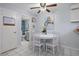 Bright dining area with white table set, adjacent to the kitchen and bathroom at 2612 6Th Ct, Palm Harbor, FL 34684
