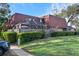Charming townhome with well-manicured lawn, screened patio, and American flags waving at 2612 6Th Ct, Palm Harbor, FL 34684