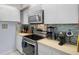 A well-equipped kitchen featuring stainless steel appliances and stylish mosaic backsplash at 2612 6Th Ct, Palm Harbor, FL 34684