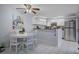 Eat-in kitchen with white cabinetry, stainless steel appliances, and tile flooring at 2612 6Th Ct, Palm Harbor, FL 34684