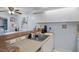Kitchen view showing breakfast bar open to dining area, stainless sink, and ample counter space at 2612 6Th Ct, Palm Harbor, FL 34684