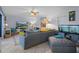 Bright living room with comfortable gray sectional, tile floors, and modern decor at 2612 6Th Ct, Palm Harbor, FL 34684