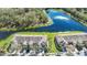 Aerial view of homes showcases their prime location next to a serene lake and lush green space at 2824 Conch Hollow Dr, Brandon, FL 33511