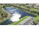 An aerial view captures the community's tranquil setting by a pond with mature trees at 2824 Conch Hollow Dr, Brandon, FL 33511