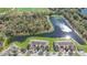 Aerial view showcasing the homes nestled next to a lake, with athletic fields and lush trees nearby at 2824 Conch Hollow Dr, Brandon, FL 33511