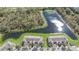 Aerial view displays the neighborhood featuring serene lakefront living with lush tree coverage and homes at 2824 Conch Hollow Dr, Brandon, FL 33511