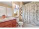 Bathroom with floral shower curtain, wood vanity, and decorative mirrors at 2824 Conch Hollow Dr, Brandon, FL 33511