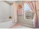 Cozy bathroom featuring a shower with curtain and window at 2824 Conch Hollow Dr, Brandon, FL 33511