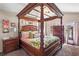 Elegant bedroom boasts a luxurious four-poster bed and sophisticated decor at 2824 Conch Hollow Dr, Brandon, FL 33511
