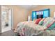 Relaxing bedroom features a bed with beach-themed decor and bathroom doorway at 2824 Conch Hollow Dr, Brandon, FL 33511