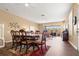 Spacious dining area with wood floors, modern lighting, and a view of the living room and screened-in porch at 2824 Conch Hollow Dr, Brandon, FL 33511