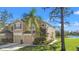Inviting two-story townhome with attached garages and a well-maintained lawn, located near a serene pond at 2824 Conch Hollow Dr, Brandon, FL 33511