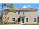 Charming two-story home featuring a blue front door with wreath and well-maintained landscaping at 2824 Conch Hollow Dr, Brandon, FL 33511