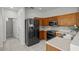 Well-equipped kitchen with stainless steel appliances, wood cabinets, and tiled backsplash; a chef's delight at 2824 Conch Hollow Dr, Brandon, FL 33511