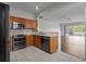 Open kitchen featuring wood cabinets, stainless steel appliances, and a view to the living room; perfect for entertaining at 2824 Conch Hollow Dr, Brandon, FL 33511
