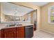 Functional kitchen featuring wood cabinets, stainless steel appliances, and an open view to other living spaces at 2824 Conch Hollow Dr, Brandon, FL 33511