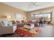 Bright living room with stylish furniture, ceiling fan, wood floors, and sliding glass doors to the patio at 2824 Conch Hollow Dr, Brandon, FL 33511