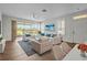 Bright living room featuring hardwood floors, comfortable seating, and sliding glass doors to the lanai at 2824 Conch Hollow Dr, Brandon, FL 33511