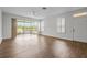 Bright, spacious living room with hard floors, sliders to porch, and scenic lake views; ample natural light at 2824 Conch Hollow Dr, Brandon, FL 33511