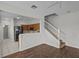 Open-concept living area with updated flooring, white staircase and adjacent kitchen at 2824 Conch Hollow Dr, Brandon, FL 33511