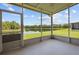 Spacious screened patio offering a serene and unobstructed view of the tranquil lake and lush surroundings at 2824 Conch Hollow Dr, Brandon, FL 33511
