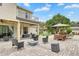 Expansive backyard featuring a fire pit, outdoor seating, and a covered patio with a barbecue grill at 3018 N 164Th Pl, Clearwater, FL 33760