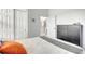 Bedroom featuring a neutral color palette, a grey upholstered bed, and a view to the stairs at 3018 N 164Th Pl, Clearwater, FL 33760