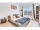 Modern bedroom with a unique bed frame, wood floors, stylish lighting, and a plush rug at 3018 N 164Th Pl, Clearwater, FL 33760