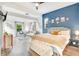 Open and bright bedroom with seating area, wooden floors, accent wall, and modern decor at 3018 N 164Th Pl, Clearwater, FL 33760