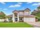 Beautiful two-story home with a well-kept lawn, brick driveway, and attached three-car garage at 3018 N 164Th Pl, Clearwater, FL 33760