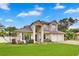 Stunning two-story home featuring a well-manicured lawn and a three-car garage, perfect for a growing Gathering at 3018 N 164Th Pl, Clearwater, FL 33760