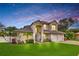 Stunning two-story home featuring a well-manicured lawn and a three-car garage, perfect for a growing Gathering at 3018 N 164Th Pl, Clearwater, FL 33760