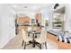 Bright kitchen featuring light wood cabinets, stainless steel appliances and an adjacent breakfast nook with a built-in bench at 3018 N 164Th Pl, Clearwater, FL 33760