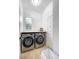 Bright laundry room with front load washer and dryer and a window for natural light at 3018 N 164Th Pl, Clearwater, FL 33760