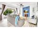 Spacious living room featuring a blue accent wall, ceiling fan, and a glass sliding door to the outdoor patio at 3018 N 164Th Pl, Clearwater, FL 33760