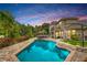 Stunning backyard oasis with a sparkling pool, lush landscaping, and spacious patio area at 3018 N 164Th Pl, Clearwater, FL 33760