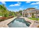 Gorgeous backyard features a refreshing pool, lush greenery, and ample space for outdoor enjoyment at 3018 N 164Th Pl, Clearwater, FL 33760