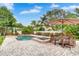 Beautiful backyard featuring a pool, spa, and a dining area shaded by a large patio umbrella at 3018 N 164Th Pl, Clearwater, FL 33760