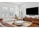 Modern living room featuring neutral furnishings, stylish lighting, and large windows with shutters at 3203 Park Green Dr, Tampa, FL 33611