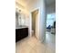 Bathroom vanity with granite countertop and doorway to toilet and bedroom at 3247 Macintosh Rd, Land O Lakes, FL 34639