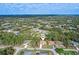 Aerial view of the home, nestled in a lush neighborhood with mature trees at 3341 Richardson St, North Port, FL 34288