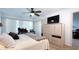 Well-lit bedroom includes a ceiling fan, a television, and a large closet for ample storage at 3400 Gulf Blvd # 304, Belleair Beach, FL 33786