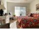 Bright bedroom with large window, light-colored dresser, and a cozy floral bedspread at 3400 Gulf Blvd # 304, Belleair Beach, FL 33786