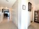 Hallway view showing closet, hallway, and a glimpse of the living area with balcony view at 3400 Gulf Blvd # 304, Belleair Beach, FL 33786