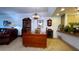 Comfortable living area with a wooden table, brown leather sofa, and bright lighting at 3400 Gulf Blvd # 304, Belleair Beach, FL 33786